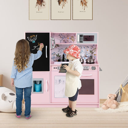 Two children playing with the cream pink play kitchen set in a room
