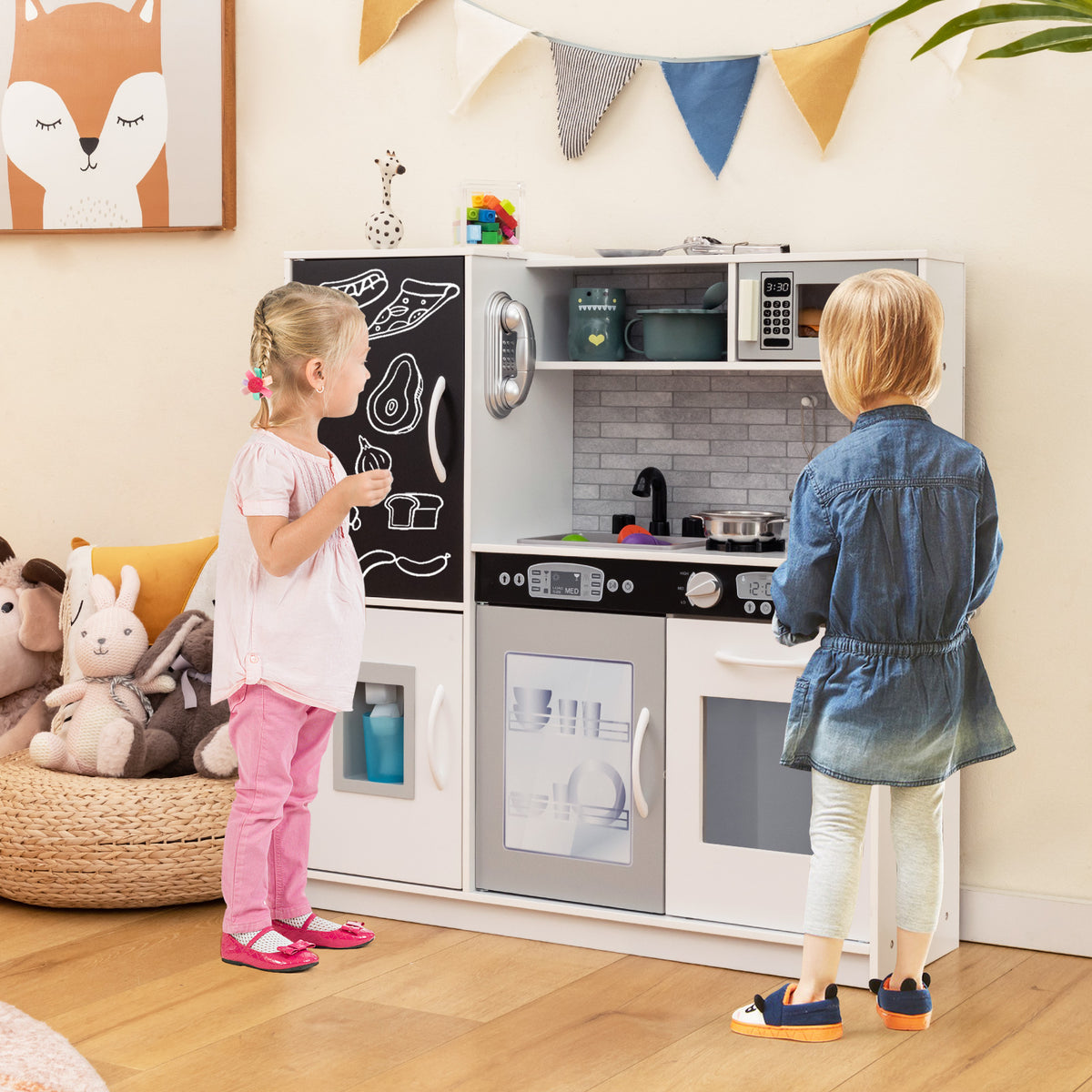 Two children playing with the play kitchen set in a bright living room with toys and decorations