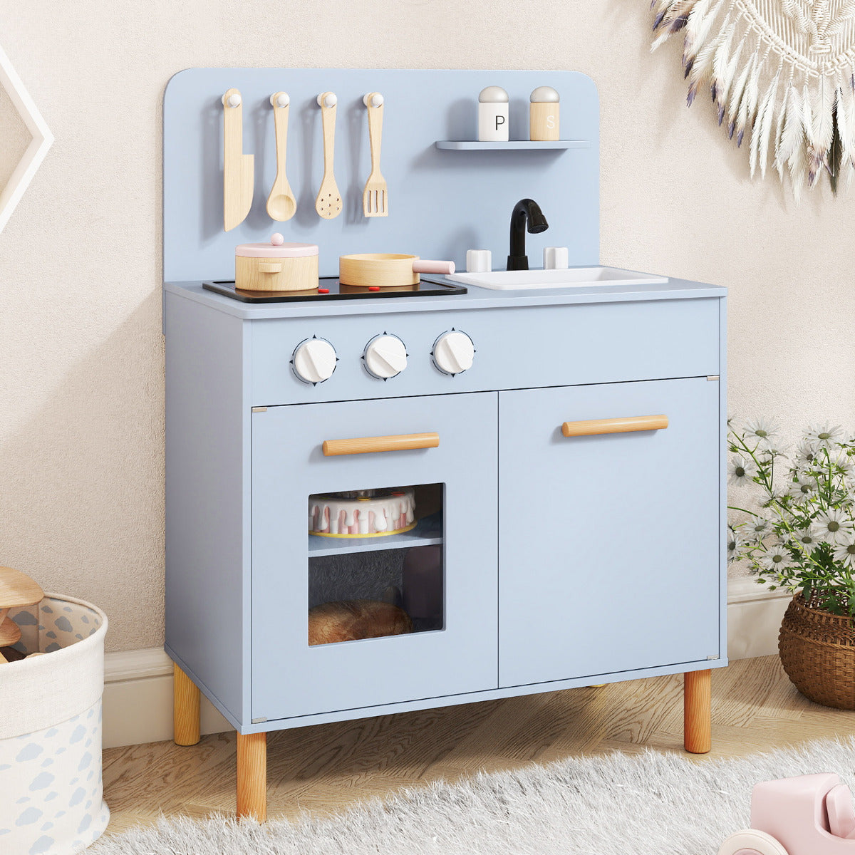 Blue play kitchen set with accessories in a room setting