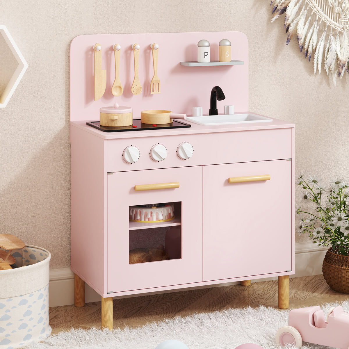 The play kitchen set placed in a bright room with a rug and decorative wall hangings
