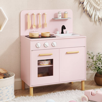The play kitchen set placed in a bright room with a rug and decorative wall hangings