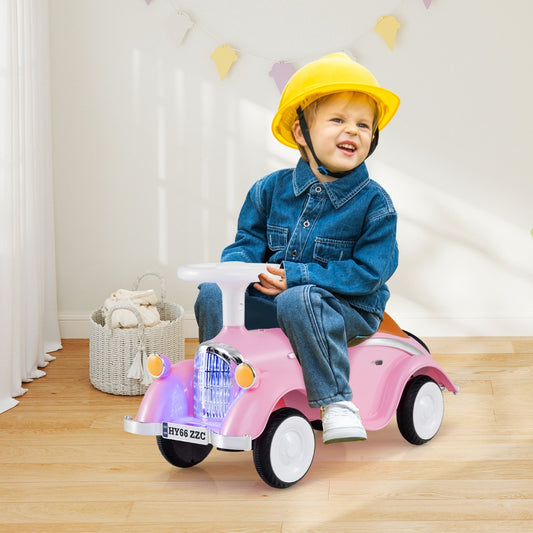 A young child wearing a yellow hard hat and denim clothes riding the pink push and pedal ride on toy