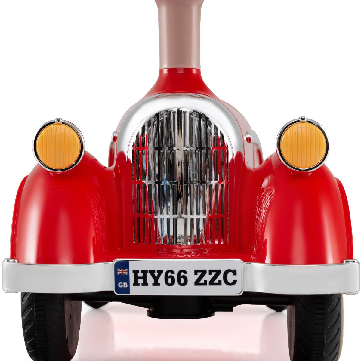 The front of a red ride on car showing the grille, headlights and a UK number plate
