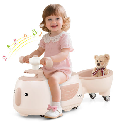 A toddler girl enjoys the beige ride on toy with trailer, with musical notes indicating sound effects