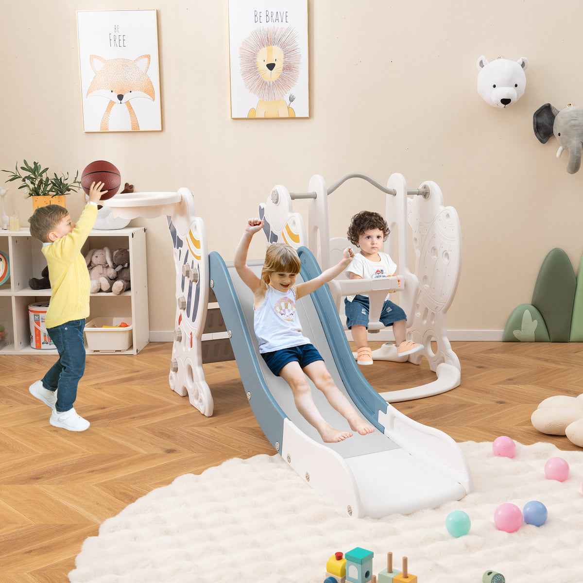 Children playing on the blue and white kids slide and swing set indoors on a rug