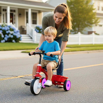 Toddler Tricycle Bike, the ride on toy being pushed by a woman while a young boy sits on it on a suburban street