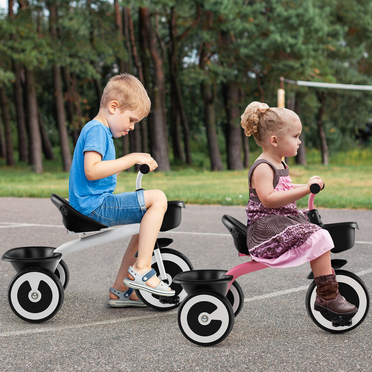 Two children ride their white and pink kids trikes outdoors