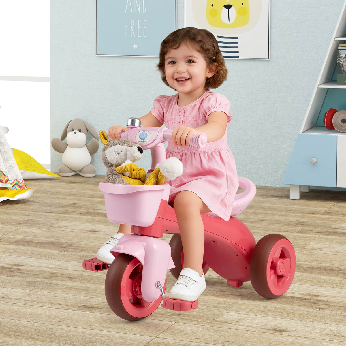 The ride on toy with a plush toy in the front basket being ridden by a girl indoors