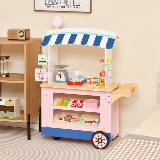 The wooden shop cart with a blue striped roof and pink base stands on a patterned rug