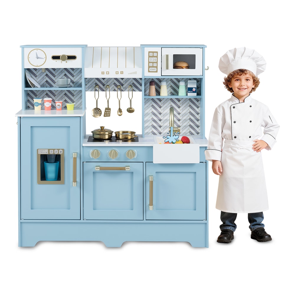Child in chef outfit standing by the blue toy kitchen playset
