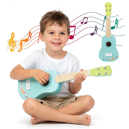 A happy young boy sitting on the floor, strumming a light blue toy ukulele with a natural wood neck