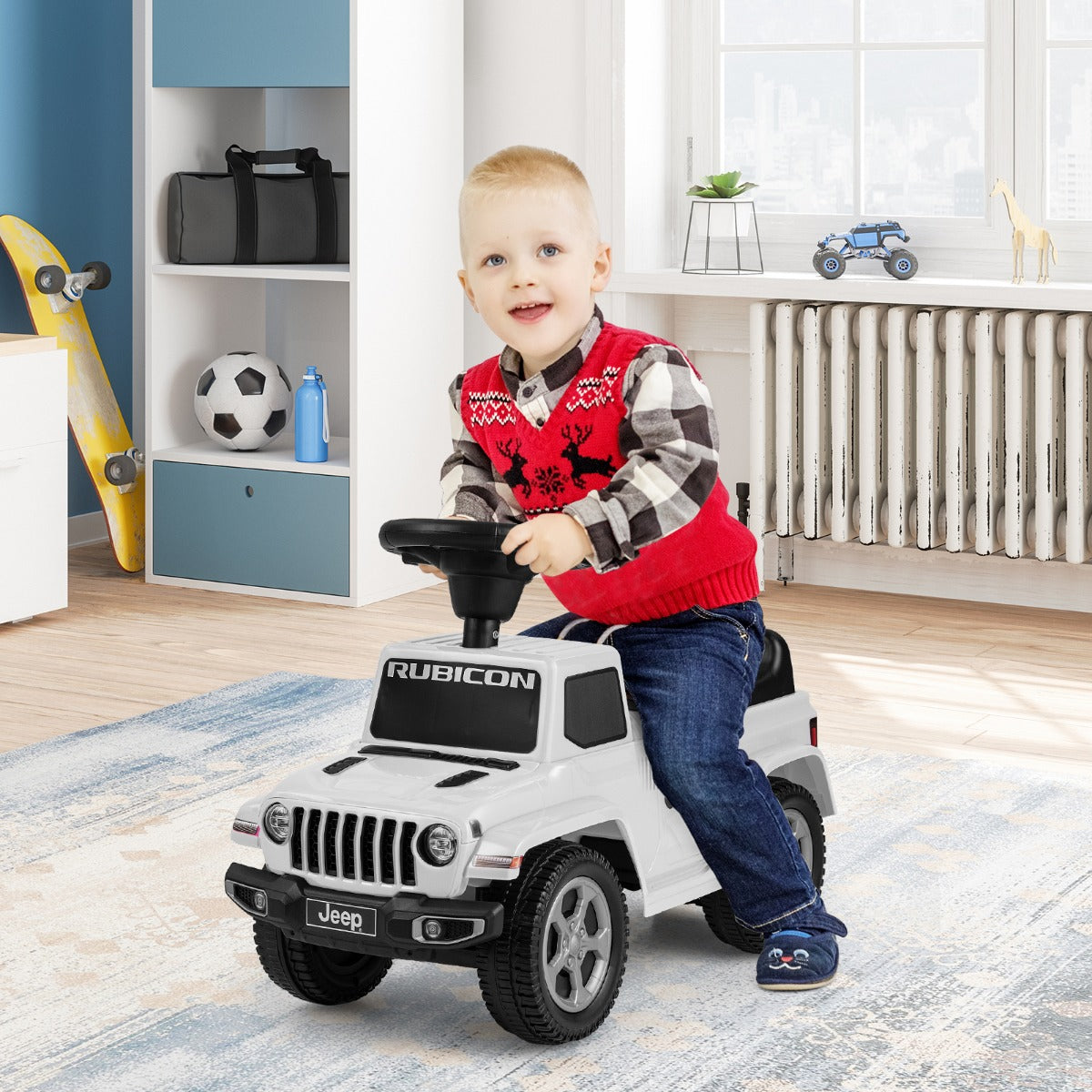 A young boy in a red checked waistcoat sits on the white ride on push car indoors
