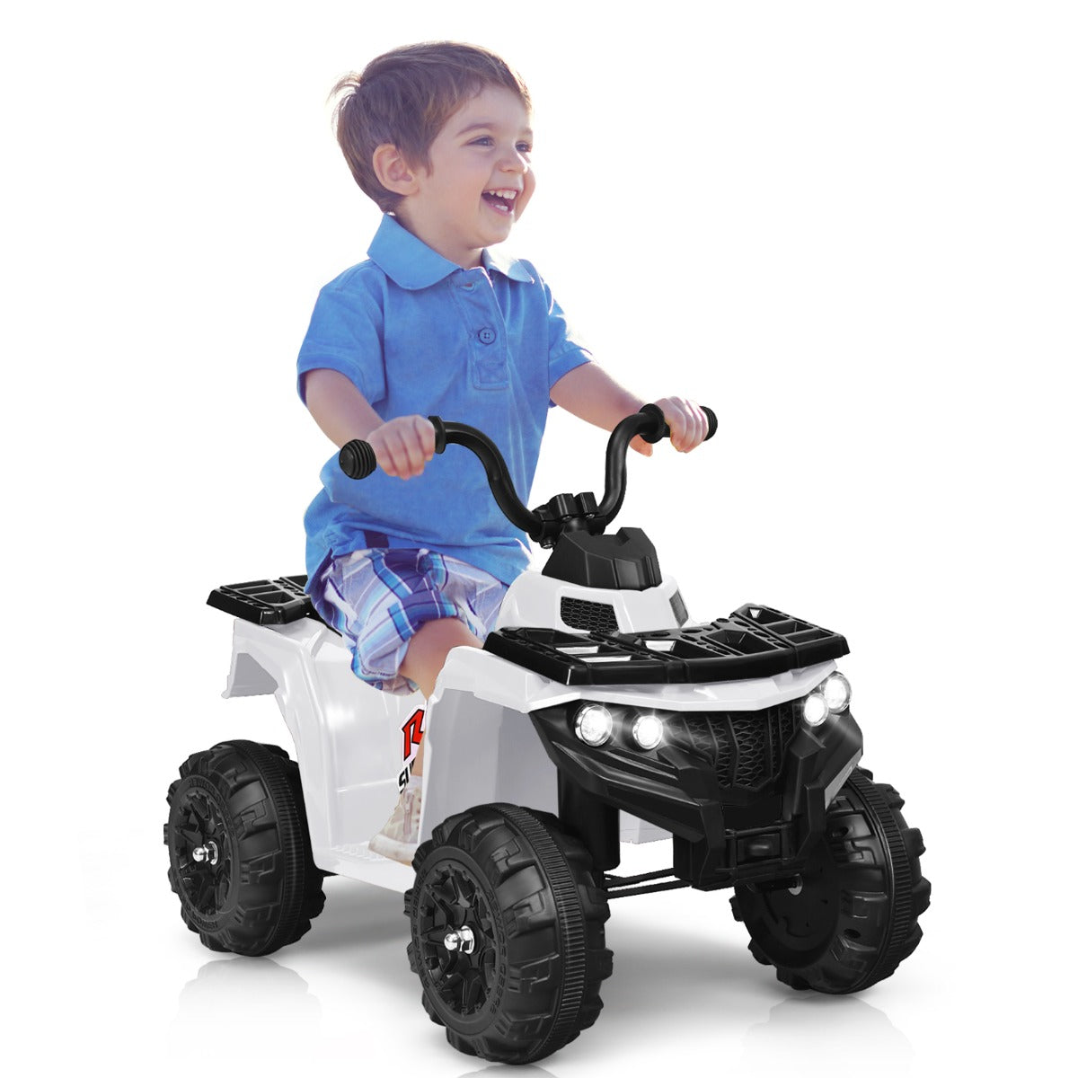 A happy young boy sits on the white kids electric quad bike outdoors