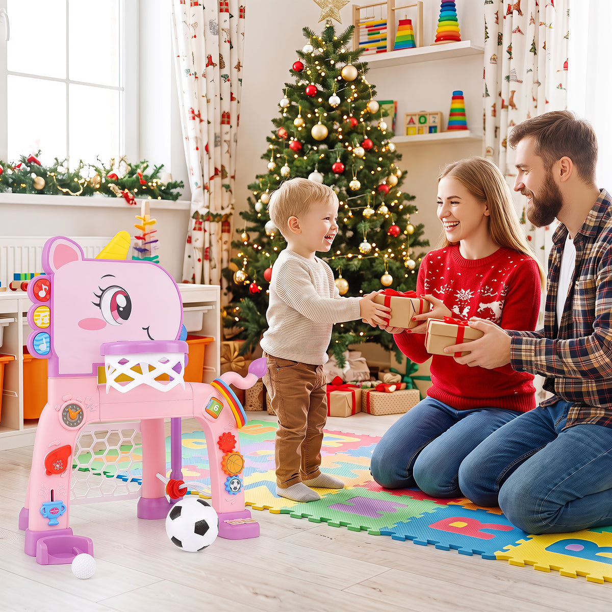 A family with a Christmas tree and the pink unicorn toddler sports activity centre