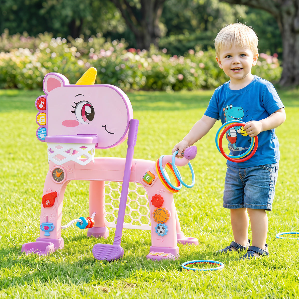 A pink unicorn toddler sports activity centre with a basketball hoop and soccer goal in a garden