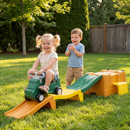 The ride on toy set up on a grassy lawn with two children playing together