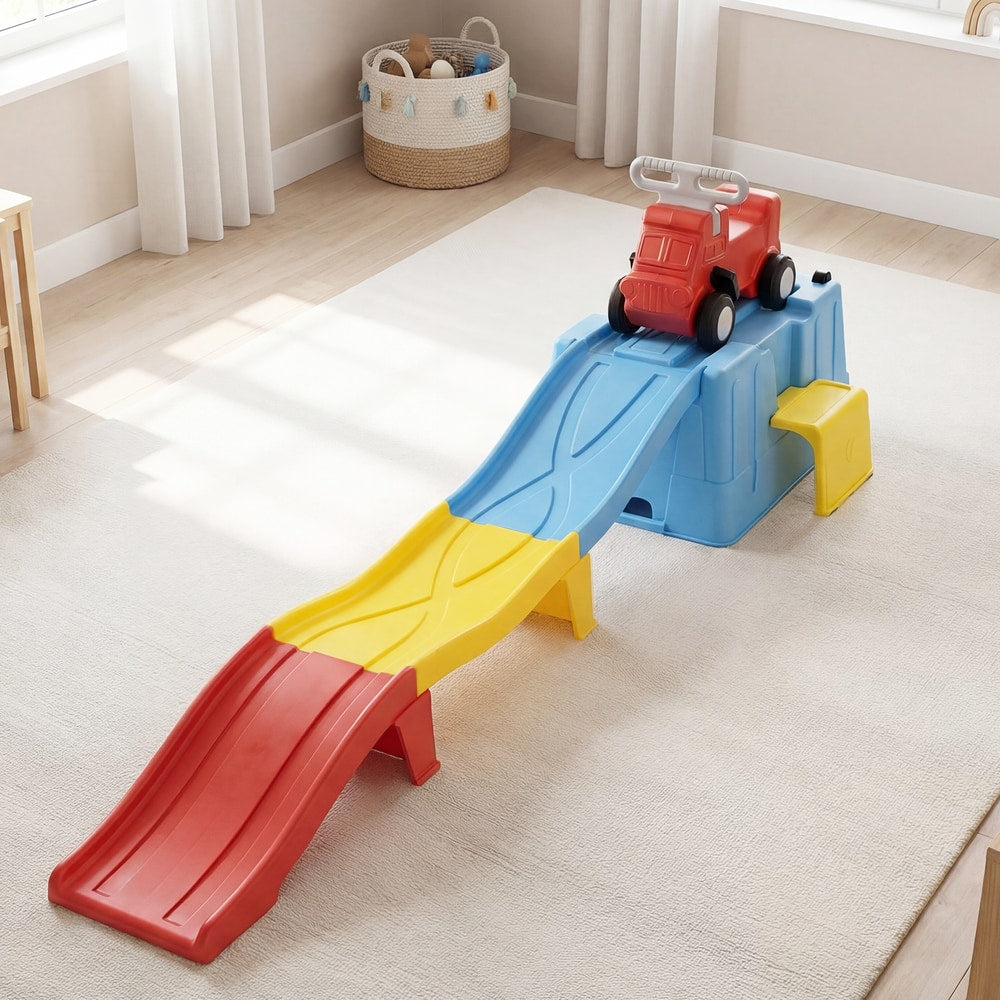 The blue, yellow and red roller coaster track with the red car on top, set up on a rug