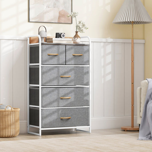 Grey fabric dresser storage tower with wooden top in a bedroom setting