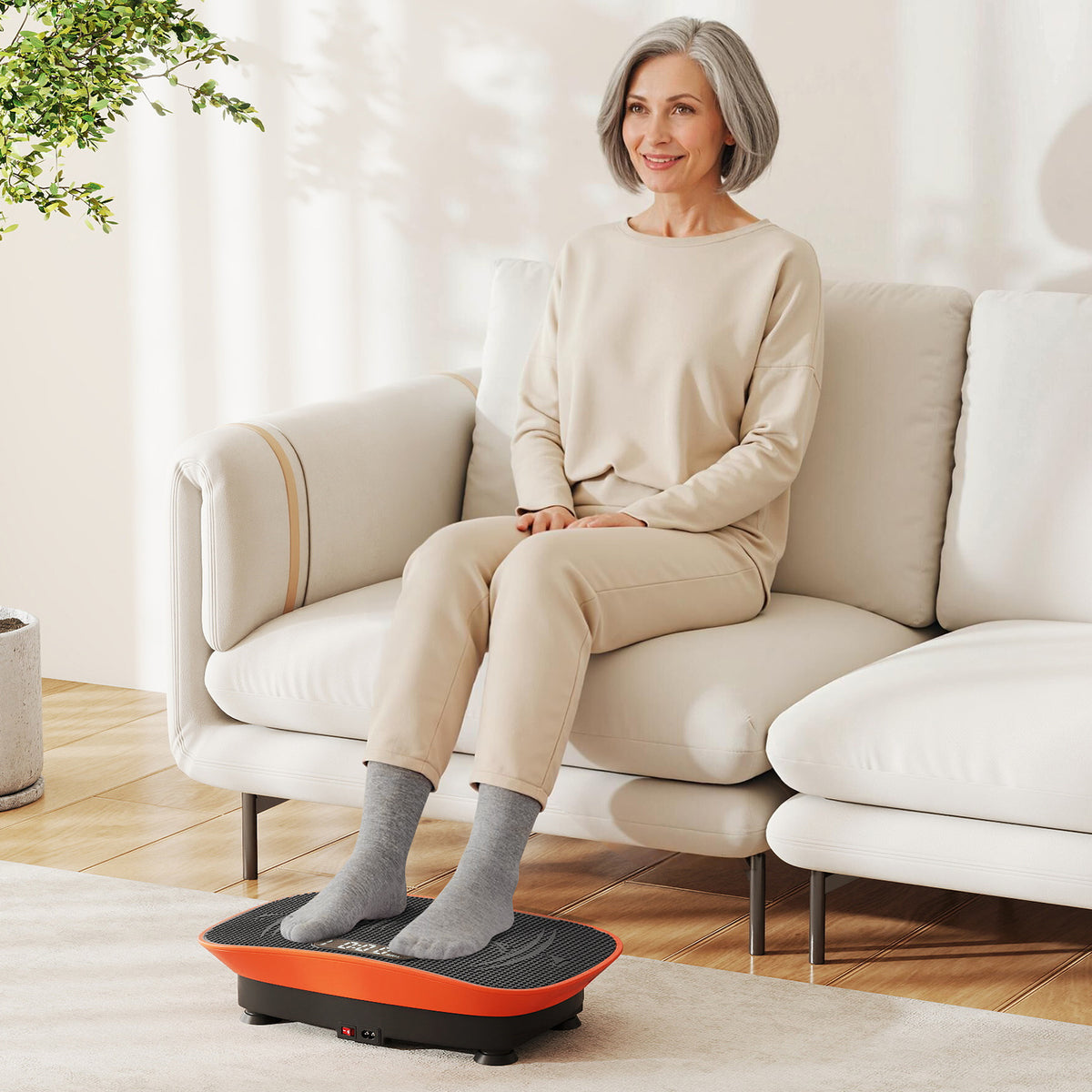Woman sitting on a sofa using the orange exercise machine