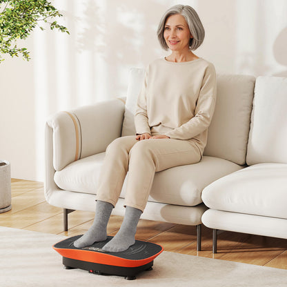 Woman sitting on a sofa using the orange exercise machine