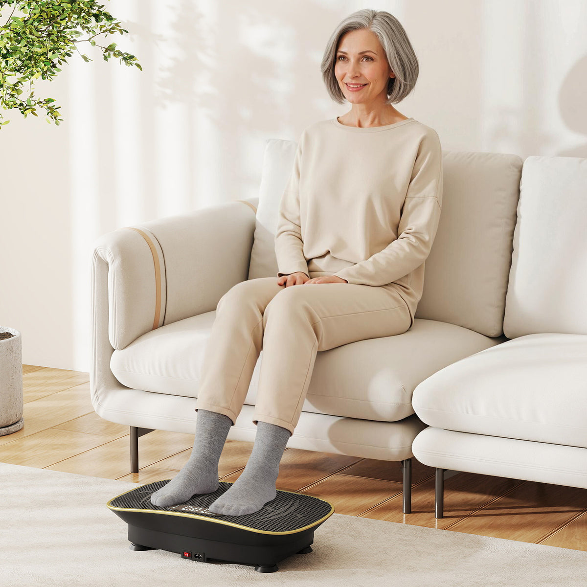 A woman sitting on a sofa using the exercise machine