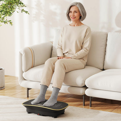 A woman sitting on a sofa using the exercise machine