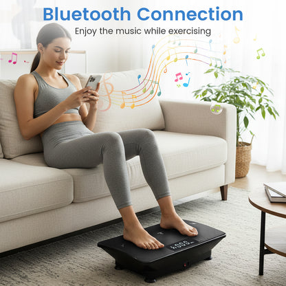 The exercise machine being used by a woman sitting on a sofa while using her mobile phone