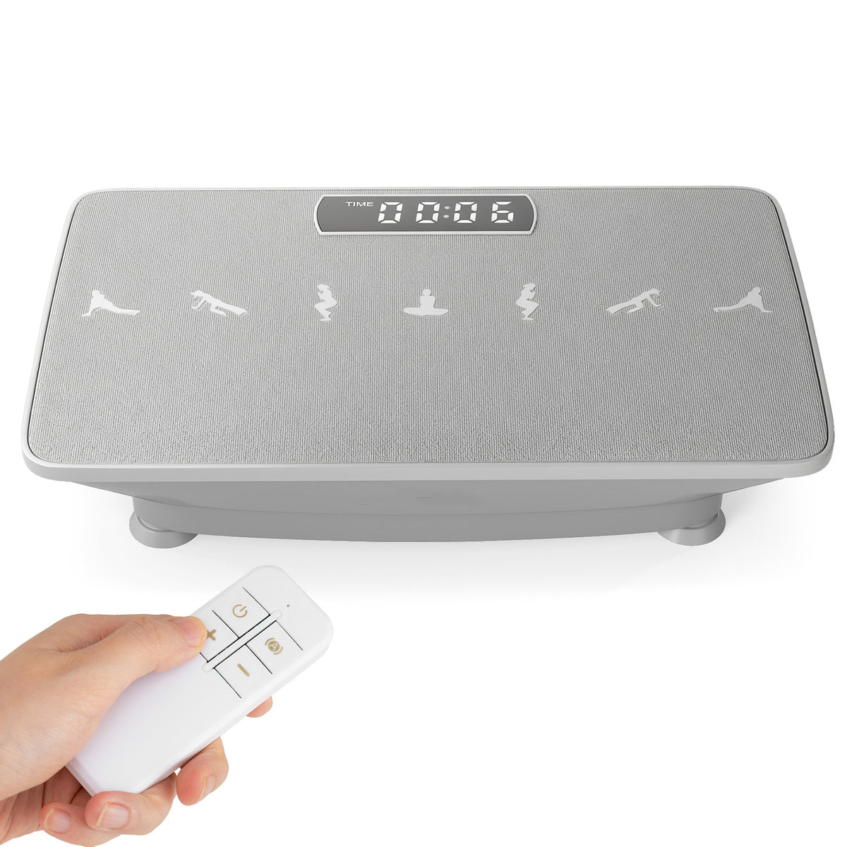 The grey exercise machine with a remote control held in a hand, showing the display and icons