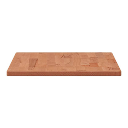 The table top seen from the side showing the thickness and the layered wood construction