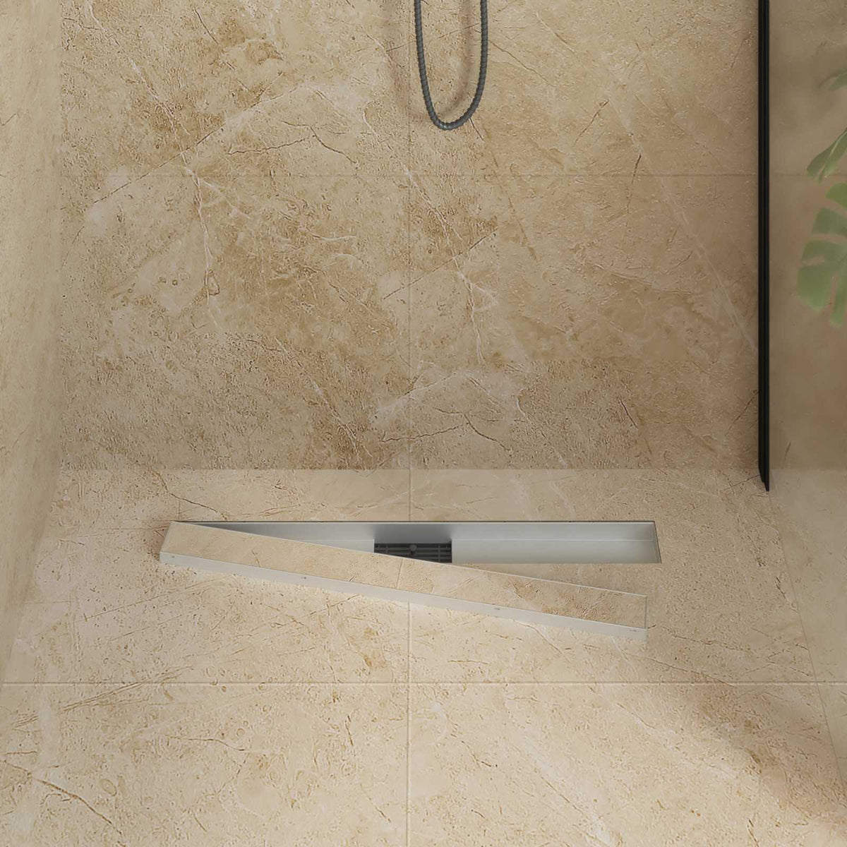 The shower drain with the cover plate partially removed to show the internal filter
