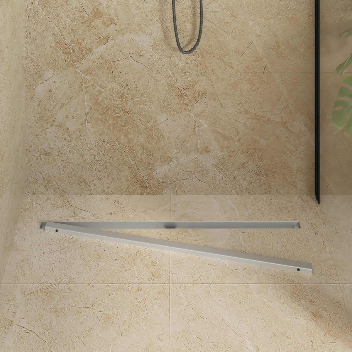 The slim shower drain frame laid out on a tiled floor