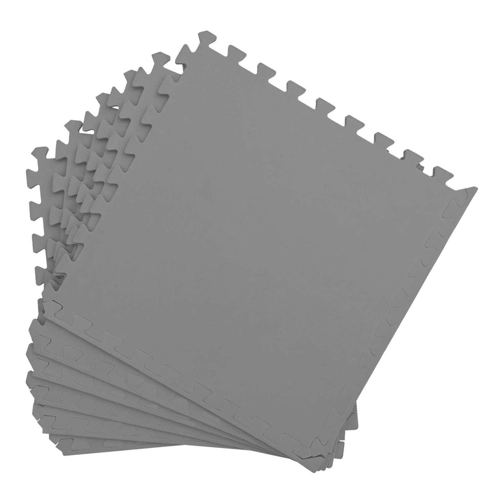 A fanned out stack of grey interlocking pool ground mats showing their puzzle edges