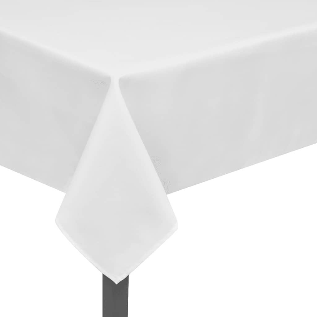 The white tablecloths covering a rectangular table surface with a corner hanging down