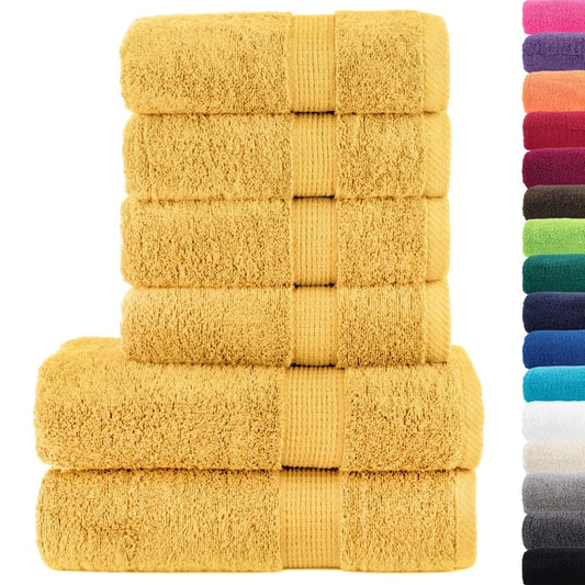A stack of gold towels next to a selection of other coloured towels