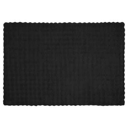 A flat black faux rabbit fur blanket with a scalloped edge