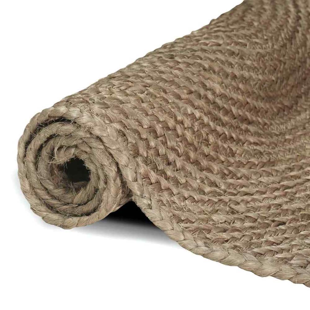 Rolled up grey jute rug showing the braided edge