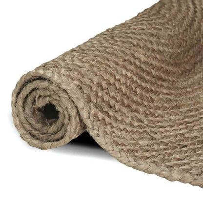 Rolled up grey jute rug showing the braided edge