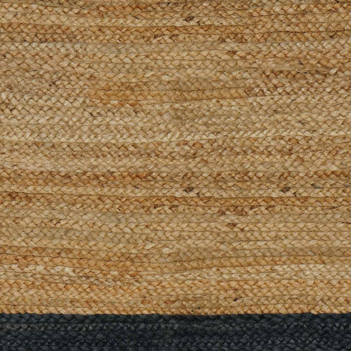 Close up of the natural jute weave and dark grey border of the rug