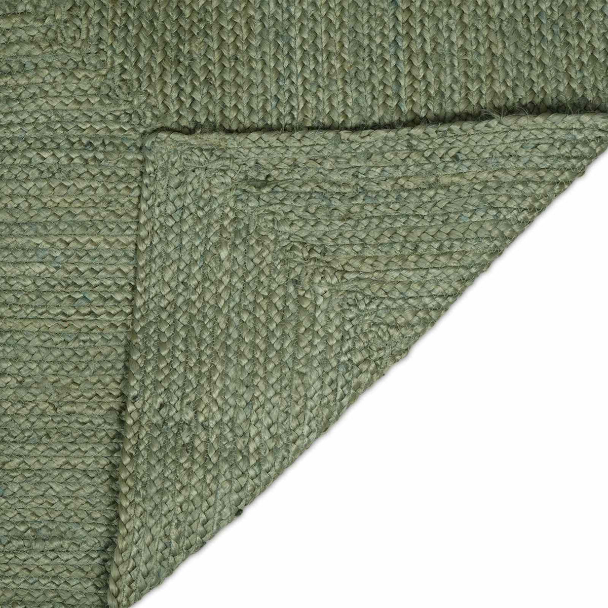 The area rug with one corner folded over to reveal the underside of the woven material