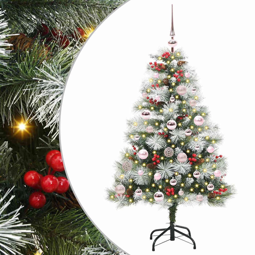 Close up of the green and white artificial Christmas tree branches with red berries and baubles