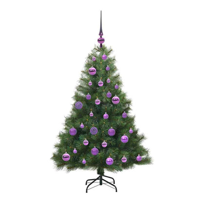 The artificial Christmas tree standing on a black metal stand, topped with a purple finial