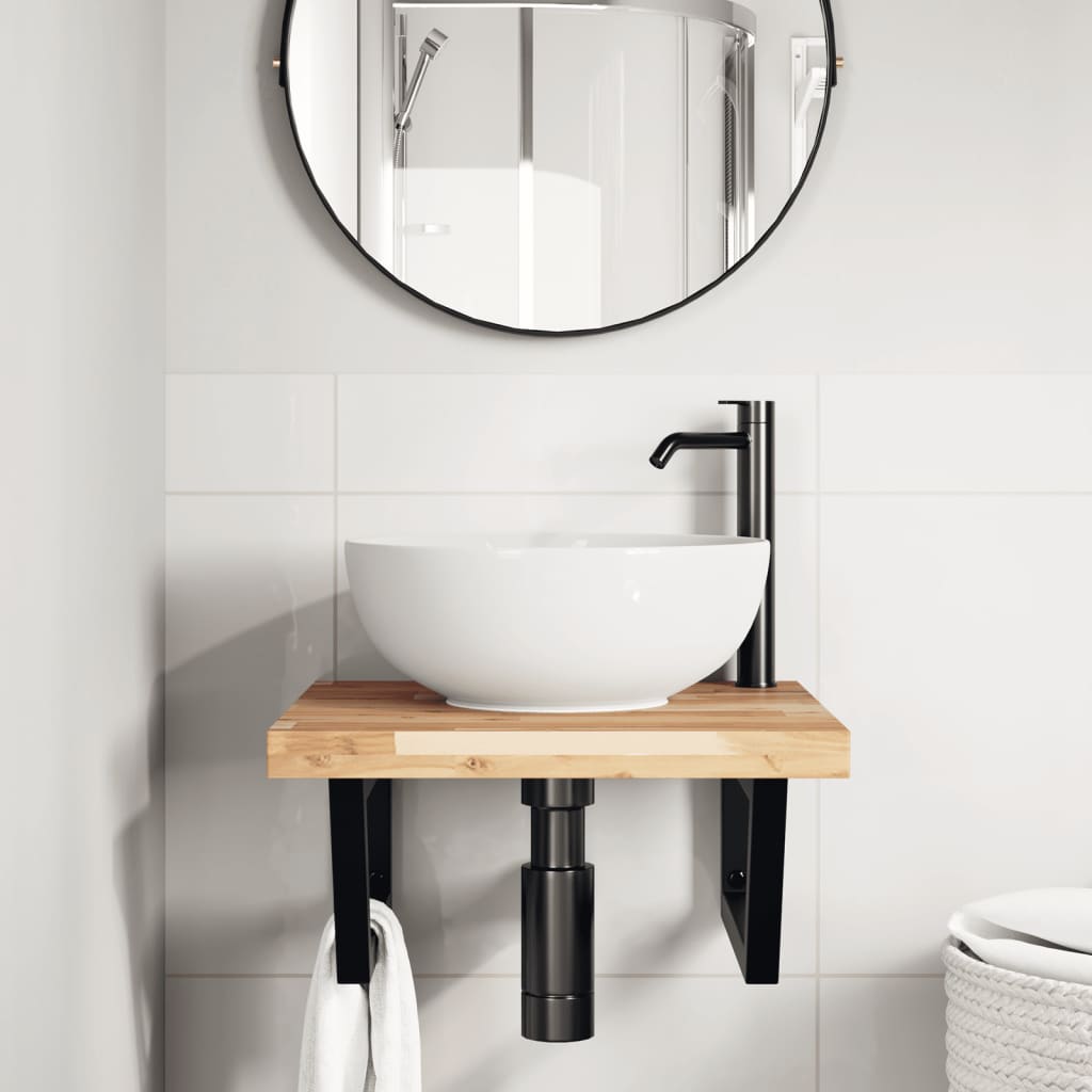 Bathroom vanity unit with a white basin and black tap in a tiled room