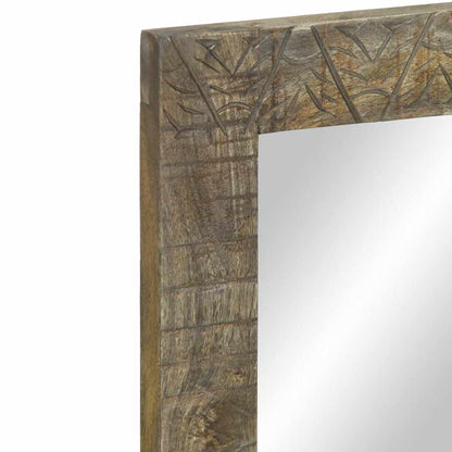 A close-up of the top corner of the bathroom mirror frame with carvings