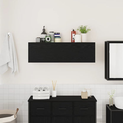 The black wall cabinet is mounted on a wall above a vanity unit in a bathroom