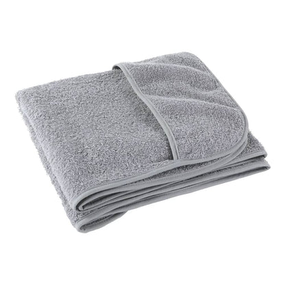 A folded grey beach towel showing its textured fabric and hemmed edge