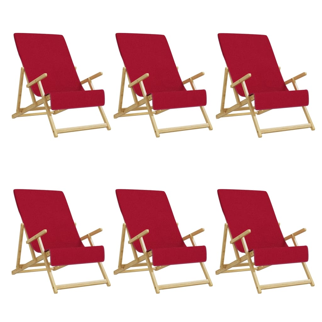 The beach towels draped over six wooden sun loungers set against a plain white background