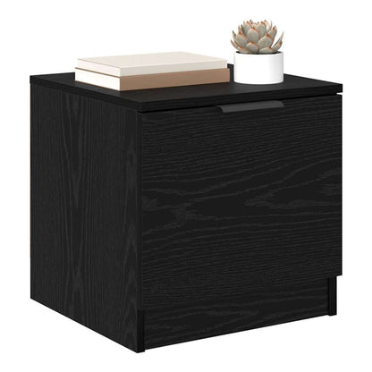 Close-up of a black oak bedside table showing the wood grain texture and handle