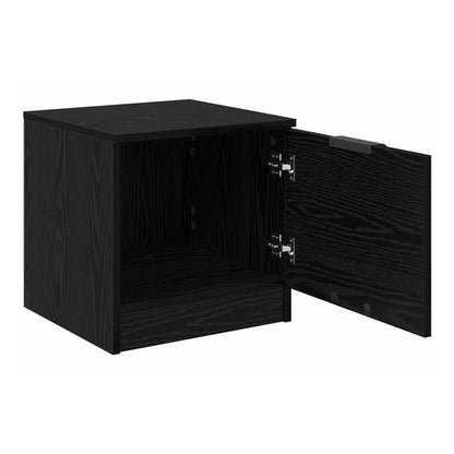 A black oak bedside cabinet with its door open showing storage space