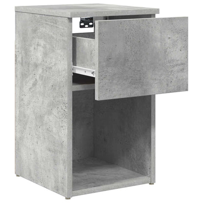 A concrete grey bedside cabinet with its drawer open, showing the interior runners