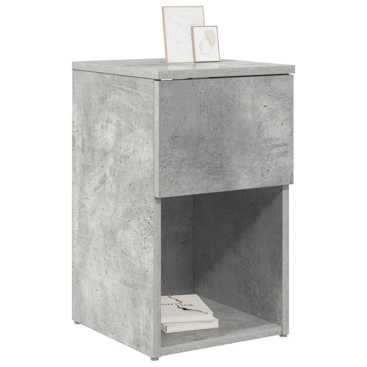 A concrete grey bedside cabinet with a drawer and open shelf, decorated with framed pictures and a book